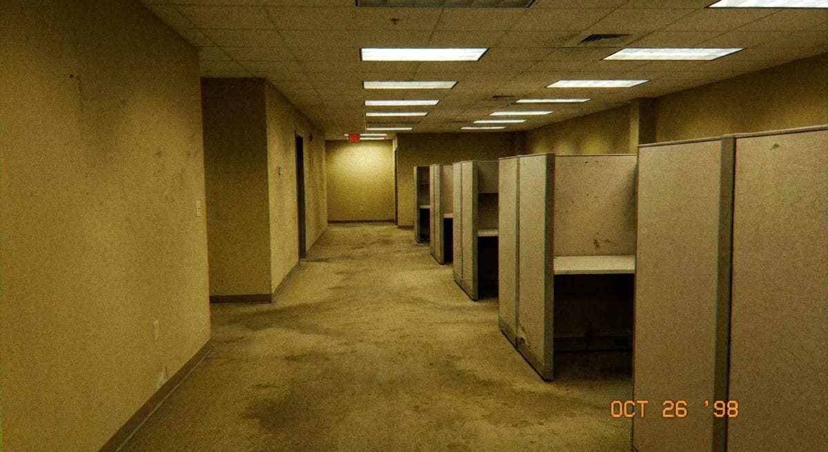 Office transformed into liminal space with eerie fluorescent lighting - The Backrooms aesthetic